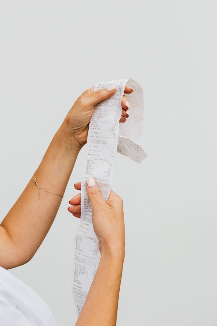 Close-up of Woman Hands Holding Bill